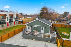 View of front facade featuring a fenced backyard, a deck, a residential view, and a patio