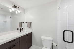 Full bathroom featuring a stall shower and vanity