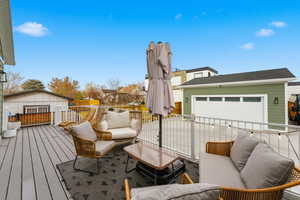 Wooden deck with an outdoor hangout area and an outdoor structure