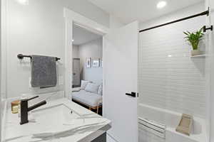 Full bath featuring vanity, tub / shower combination, recessed lighting, and ensuite bath