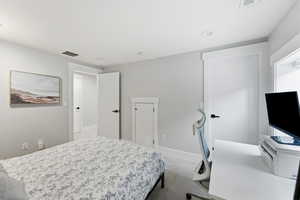 Bedroom featuring light colored carpet and baseboards