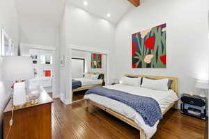 Bedroom with high vaulted ceiling, a closet, dark wood-style flooring, beam ceiling, and recessed lighting