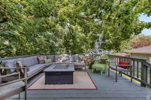 Deck featuring an outdoor living space with a fire pit