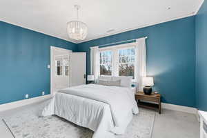 Bedroom with a chandelier and ornamental molding