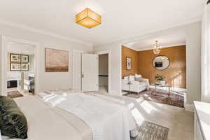 Bedroom with a chandelier, crown molding, and concrete flooring