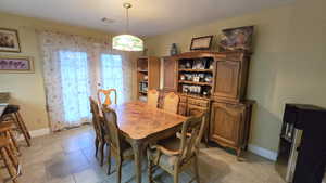 Dining room with light tile patterned floors and baseboards