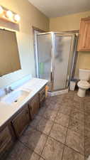 Bathroom featuring vanity and a stall shower