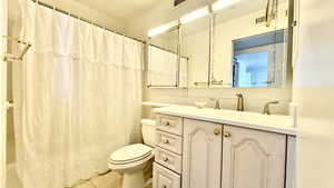 Full bath featuring vanity and light tile patterned floors