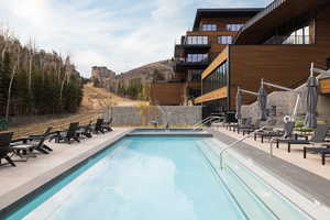 Community pool with a patio and a mountain view
