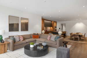 Living room featuring light wood finished floors and recessed lighting