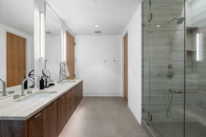 Bathroom with double vanity and a stall shower