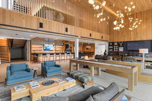 Building lobby featuring stairs, wooden walls, and a high ceiling