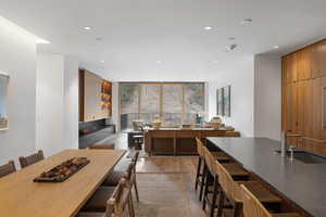 Dining room featuring expansive windows, light wood-style flooring, and recessed lighting