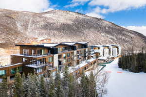 Snow covered house featuring a mountain view