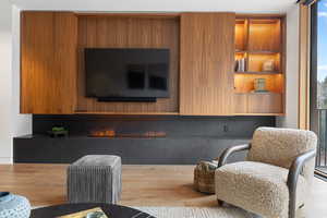 Living area featuring wood finished floors and a fireplace