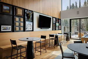 Dining space with a towering ceiling and light wood-style flooring