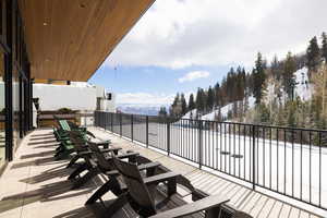 Snow covered patio featuring a patio and a mountain view