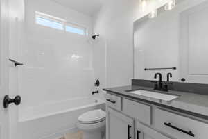 Full bath featuring  shower combination and vanity