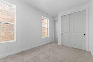 Unfurnished bedroom featuring carpet floors and a closet