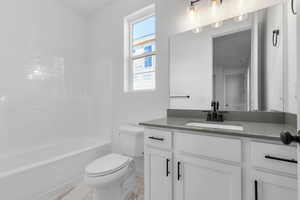 Full bath with shower / washtub combination and vanity