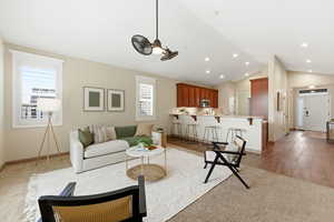 Living area featuring lofted ceiling and recessed lighting