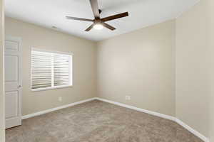 Spare room with light colored carpet and ceiling fan