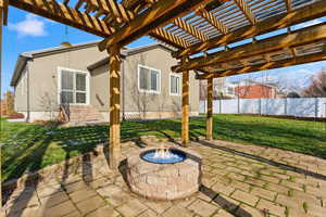 View of patio / terrace with an outdoor fire pit and a pergola
