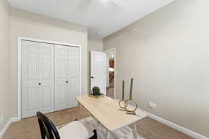 Office featuring light carpet and baseboards