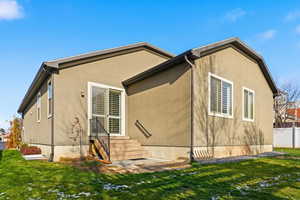 View of side of property with stucco siding and entry steps