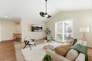 Living area featuring vaulted ceiling and wood finished floors