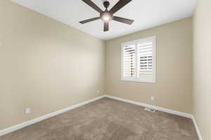 Unfurnished room featuring carpet and ceiling fan