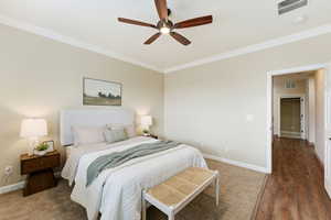 Bedroom featuring crown molding and a ceiling fan
