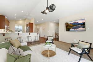 Living area featuring lofted ceiling and baseboards