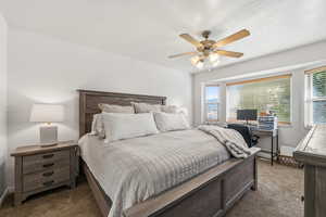 Bedroom with dark carpet and ceiling fan