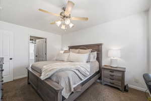 Bedroom featuring dark carpet and a ceiling fan