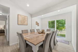 Dining area featuring light wood-style floors and recessed lighting