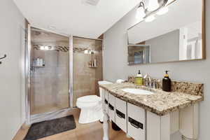Bathroom with light tile patterned flooring, vanity, and a stall shower
