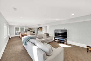 Carpeted living area with recessed lighting