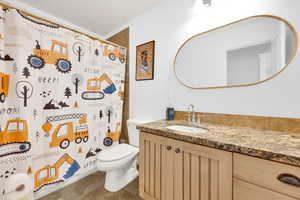 Full bath featuring vanity and curtained shower