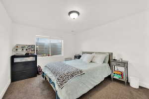 Carpeted bedroom with baseboards
