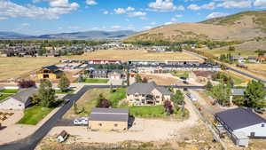 Aerial perspective of suburban area featuring a mountainous background