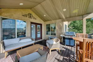Wooden terrace featuring area for grilling, french doors, and outdoor lounge area