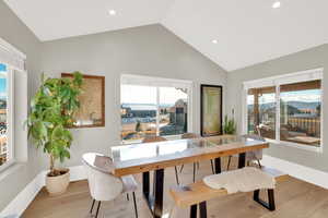 Dining area featuring wood finished floors, recessed lighting, and high vaulted ceiling