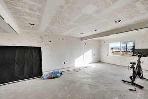 Unfurnished room featuring concrete flooring
