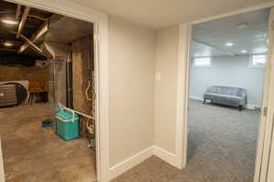 Basement with a textured ceiling and a textured wall