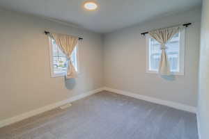 Unfurnished room with light carpet and baseboards