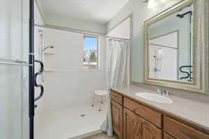 Bathroom featuring vanity and a stall shower