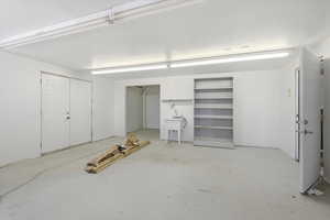 Basement featuring a garage and a sink