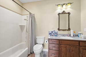 Full bath featuring shower / tub combo, vanity, and light tile patterned floors