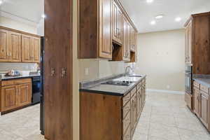 Kitchen with light tile patterned floors, recessed lighting, dishwasher, oven, and brown cabinets